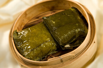steamed sticky glutinous rice and meat wrapped in lotus leaf bamboo basket hong kong dim sum menu