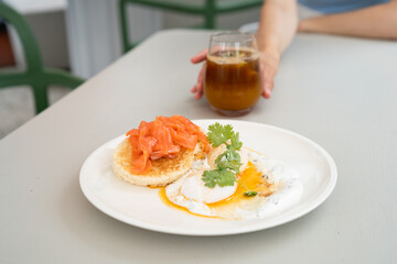 Delicious morning breakfast on a plate. Turkish eggs, creamy bread and salmon