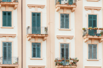 Building exterior with windows and balconies in Sicily, Italy.