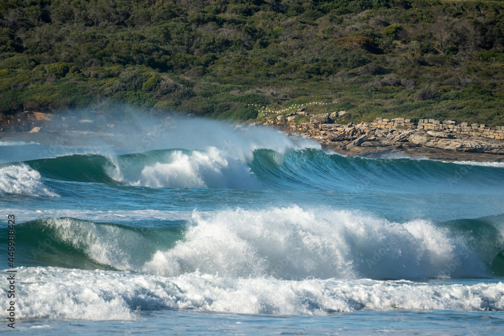 Wall mural wild waves breaking beach green blue spray