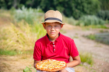 boy in red shirt wants to eat pizza