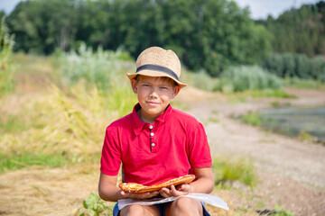 boy in red shirt wants to eat pizza