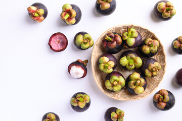 Mangosteen fruit in basket on white background, Flat lay, Tropical fruit
