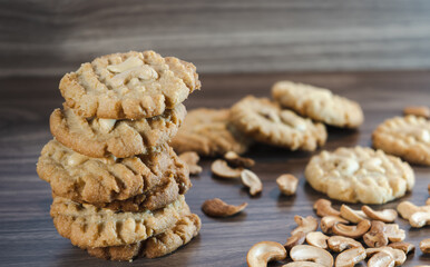 Keto cookies and cashews arranged on a wooden container
