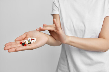 colorful pills in the palm of your hand pain reliever health treatment pharmacology