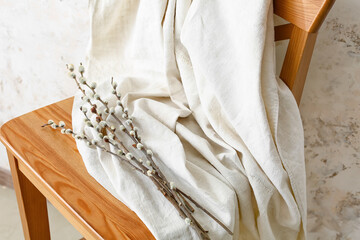 Chair with willow branches in room