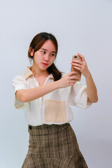 Teenager girl using mobile phone on white background,