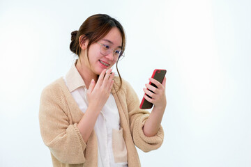 Teenager girl using mobile phone on white background,