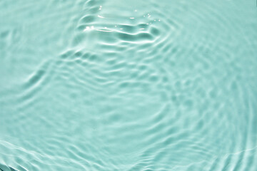 Trendy summer exotic background.  Blurred or defocused transparent clear water waves in sunlight....