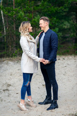 Obraz premium Happy loving couple enjoying of happiness love and tenderness, dating, romance.Couple hugging in love at spring park.