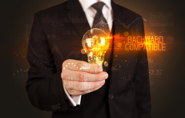 Businessman holding a lightbulb concept