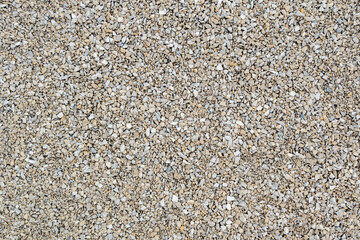 Dry white limestone ballast flat full frame background. Small gray dusty broken macadam stones texture.