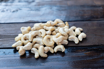 Raw cashew nuts on a wooden table close-up