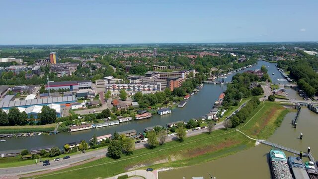 Jib down of beautiful Dutch city skyline near a long river