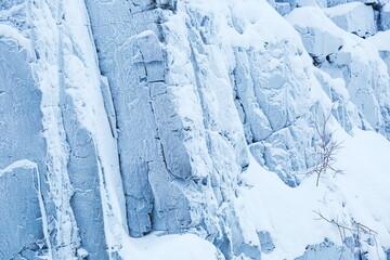 frozen rocks in frost and snow