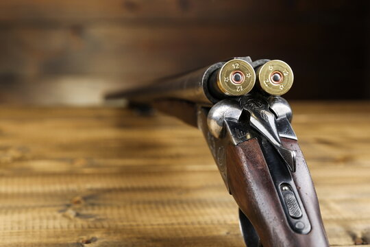 loaded hunting rifle on a wooden background close up