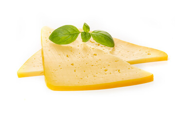 Pieces of semi-hard or hard yellow cheese with holes and basil leaf isolated on a white background.