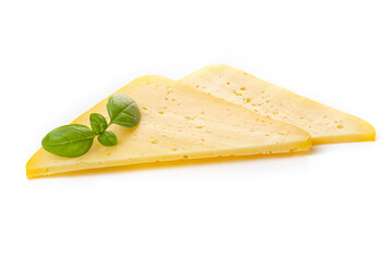 Pieces of semi-hard or hard yellow cheese with holes and basil leaf isolated on a white background.