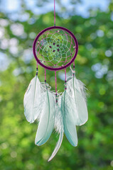 Dreamcatcher, american native amulet in forest. Shaman