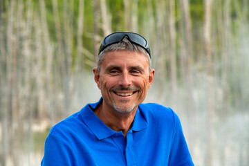 Man smiling outdoor visiting geysers.