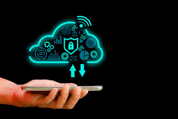 Cloud computing technology data storage concept. Hand holding smartphone or mobile with cloud and virtual icon and business, education, innovation on dark black background.