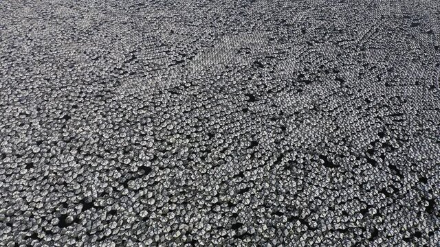 Small reflecting plates clustered together in a large water reservoir.