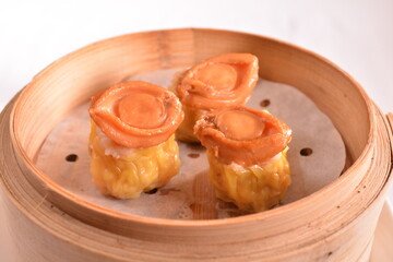 Hong Kong steamed siew mai meatball dumpling with wanton skin abalone and roe in bamboo basket...