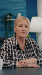 Portrait of senior woman talking and listening remote colleagues during video call, online conference, working from home. Person using online chat technology webcam making virtual meeting connection