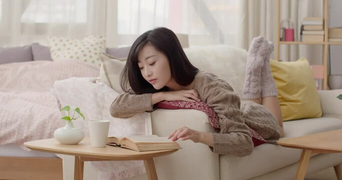 Young Chinese woman reading on sofa,4K