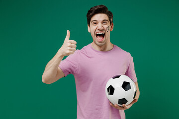 Young fun european man fan supporter wears basic pink t-shirt cheer up support football sport team...