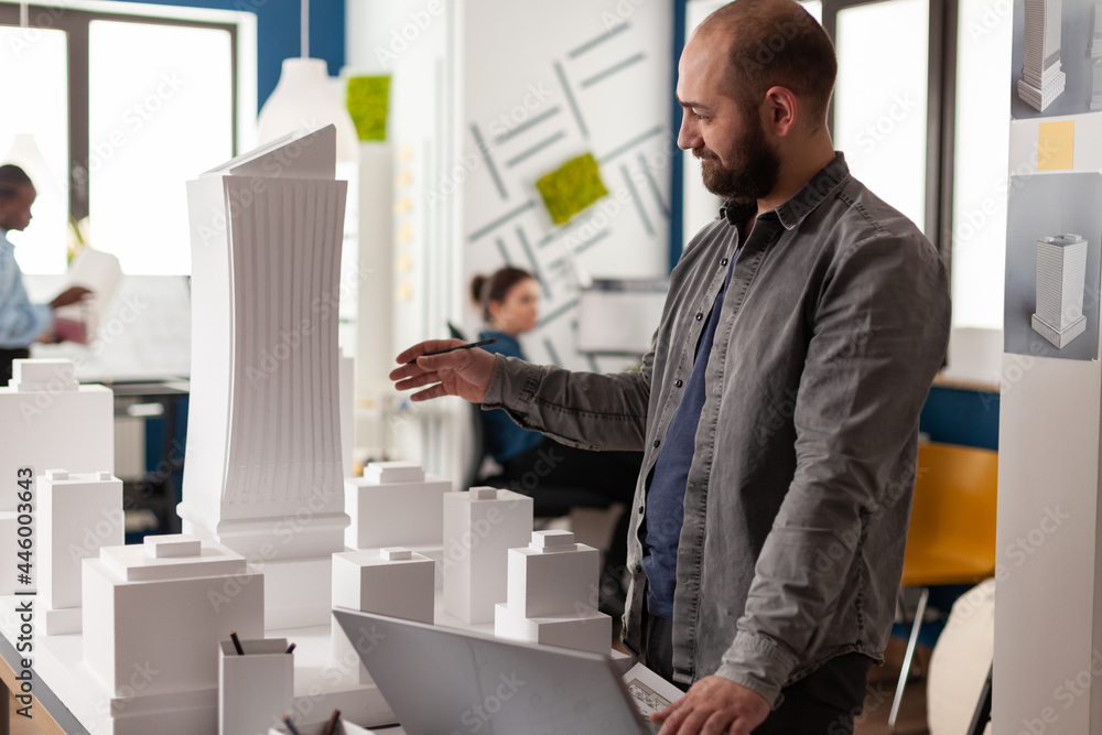 Poster architect contractor working in professional office with laptop computer for designing building mode