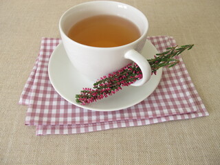 A cup of heather tea and flowering shoots from calluna vulgaris