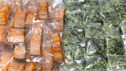 freeze cooked salmon and cheesy creamed spinach in vacuum plastic packs, concept of food...