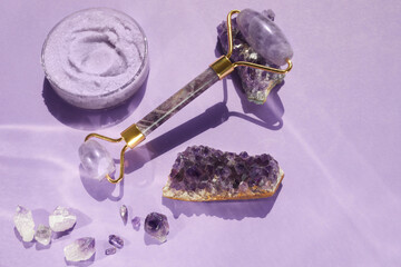 Amethyst crystals Gua sha roller massage scraper and beauty product. Moisturizer and skincare...