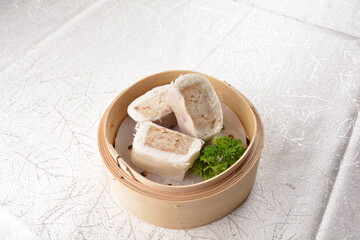 steamed teo chew white bun bao mantou wrapped with sticky glutinous rice inside in bamboo basket Hong Kong dim sum menu