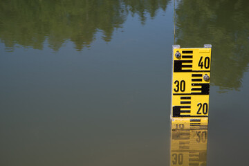 a pond with a measuring tool - obrazy, fototapety, plakaty