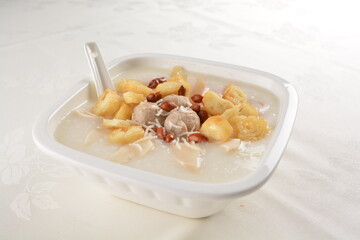 teo chew double boiled white rice ting zai porridge congee with meatball, you tiao, peanut and vegetable in square bowl asian dim sum menu