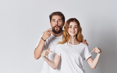 man and woman in white t-shirts advertising design