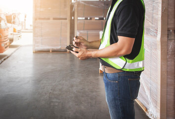 Worker Courier Holding a Smartphone and Communicating with  Customers. Delivery Sevice. Shipment...