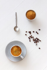 Cup of coffe on white wooden table. Flat lay, top down view.
