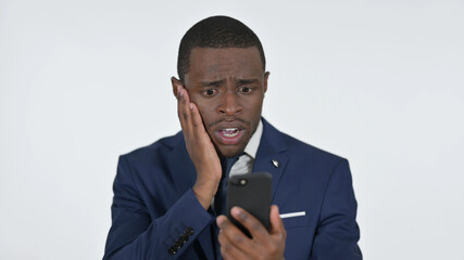 African Businessman Reacting to Failure on Smartphone, White Background