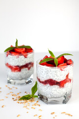 A healthy breakfast with fresh strawberries, yoghurt and chia seeds. Natural summer dessert. Сlose-up.