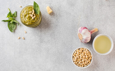 Homemade pesto sauce with basil leaves, garlic, olive oil, pine nuts. Top view. Copy space.