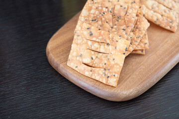 Fried crispbread on cutting board on table