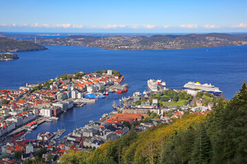 Naklejka na ściany i meble Ariel view of Bergen harbour, a lively harbor lined with colorful, gabled wooden houses, waterfront restaurants & a fish market. Norway, Scandinavia.