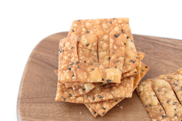 Fried crispbread on cutting board on white background