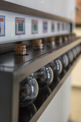 View of a wooden shelf with several old potion bottles with cork stopper, used to place chemical solutions and for other uses in antiquity