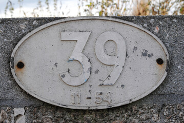 Cast Iron Number Plate '39' on Concrete Wall of Railway Bridge