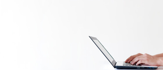 Banner of laptop and young man hands with copy space in white color background.