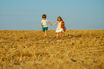 Beautiful fun day for cute friends in nature. Children has summer joy. Children play outdoors. While having fun outdoors. Positive little girl and boy. Little kid outdoor.